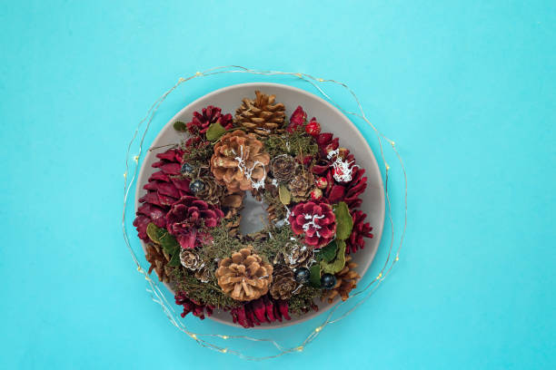 istock Plates with on Christmas wreaths decoration on blue background. Flat lay, copy space 1069248822