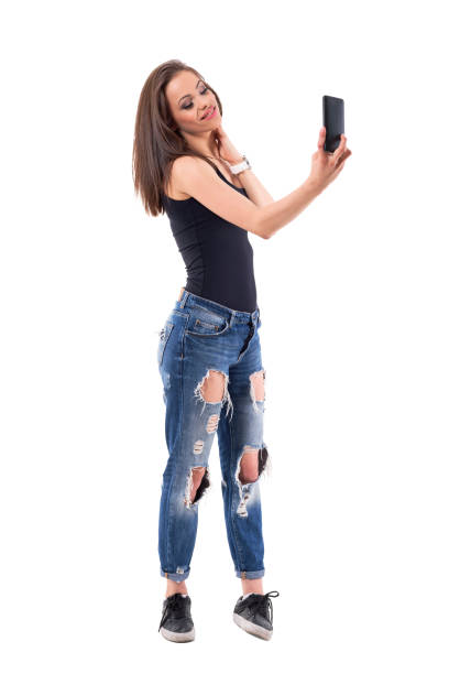 istock Affectionate feminine pretty woman taking selfie posing with hand on neck. 1069249420