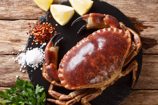 istock Fresh wild brown crab with ingredients close-up on the table. Horizontal top view from above 1069250812