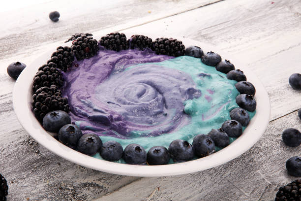 Healthy breakfast. smoothie bowl with blackberries and granola on rustic background
