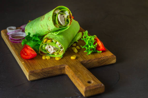istock burrito green spinach wraps with meat and vegetables  (tortilla wraps). top view. copy space 1069259846