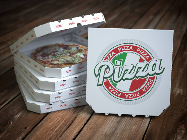 istock Pizza boxes  with pizza on vintage wooden planks. 1069259990