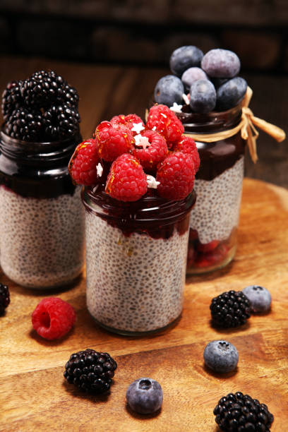 istock Healthy breakfast. chia pudding with kiwi and granola in glass on rustic background. 1069264062