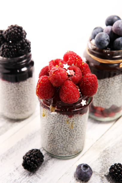 istock Healthy breakfast. chia pudding with kiwi and granola in glass on rustic background. 1069264456