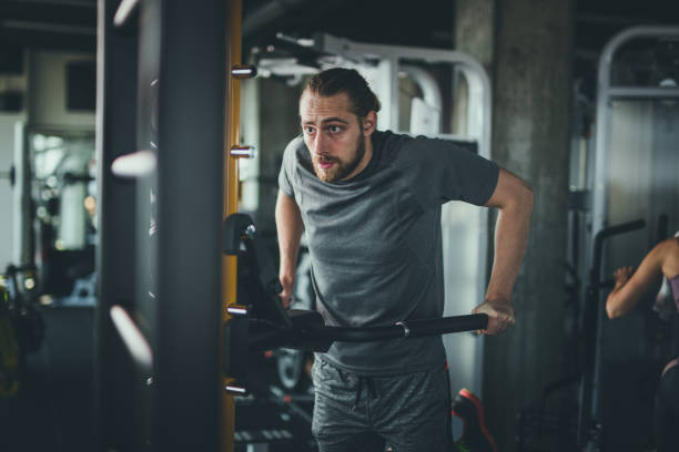 istock Young athletic man doing strength exercises in a gym. 1069265440