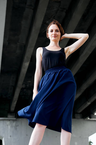 istock young girl posing under the bridge, dressed in black, modern architecture 1069280846