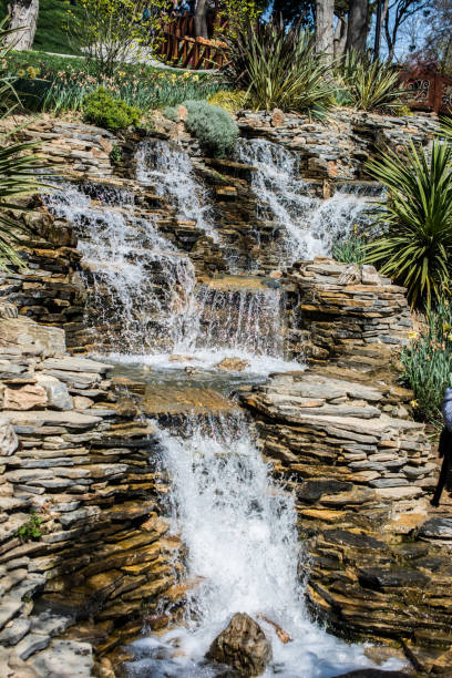 istock Small rocky waterfall pouring into a lake 1069281394