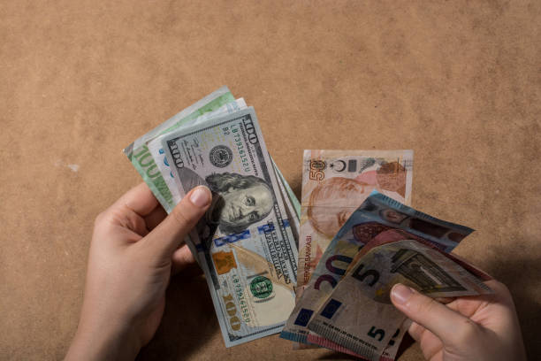 istock Hand holding American dollar  isolated on wooden background 1069281496