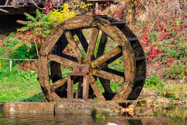 istock Working watermill wheel with falling water in the village 1069283554