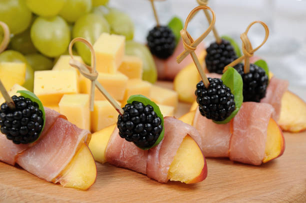 istock Canape from peach with dried ham and blackberries 1069290236
