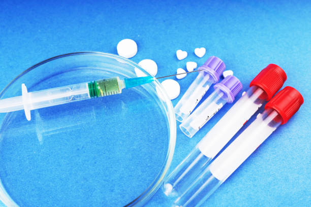 istock Medicines, Drugs, Doping, test tubes, syringe, Petri dish on a blue background. 1069293394