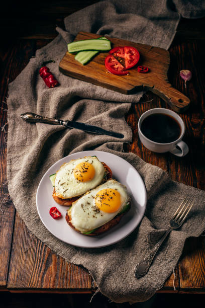 istock Breakfast toasts with vegetables and fried eggs with cup of coff 1069293424