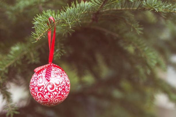istock Red Christmas ball on green fir tree 1069293750