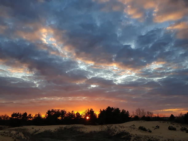 istock Fiery orange sunset colorful and speckled  clouds. Beautiful sky. 1069297220