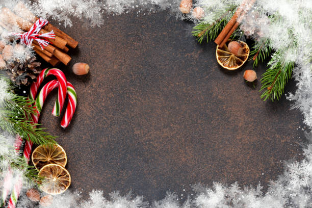 istock Christmas tree with cinnamon, nuts, candy on a brown background with space under the text. 1069299850