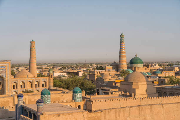 Ancient city walls of the old town of Khiva High angle view on ancient city walls and rooftops of the old town of Khiva late afternoon. Mohammed Amin Khan Madrassa samarkand urban stock pictures, royalty-free photos & images