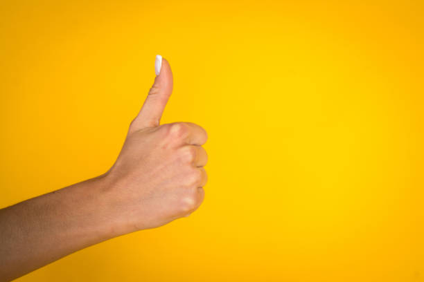 istock Woman hands over yellow background 1069301858
