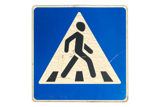 Road sign 'Pedestrian crossing' with cracks isolated on white.