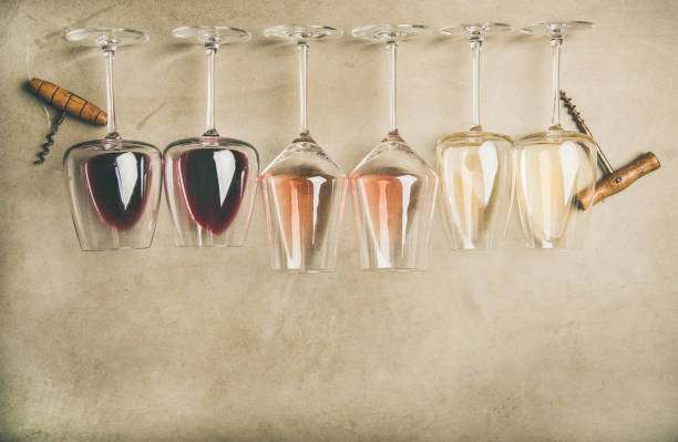 Different wines in glasses in row and corkscrews, top view Flat-lay of red, rose and white wine in glasses in row and corkscrews over grey concrete background, top view, wide composition. Wine bar, winery, wine degustation concept foxys_forest_manufacture stock pictures, royalty-free photos & images