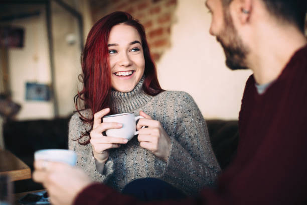 istock Beautiful young couple having coffee and using smart phone 1069307528