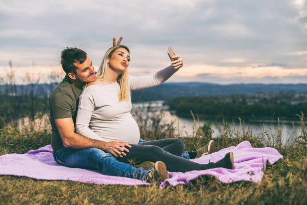 istock Husband and his pregnant wife taking selfie 1069307698
