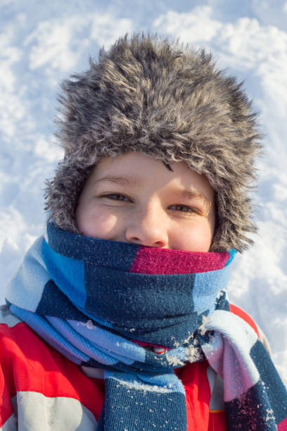 istock Adorable smiling boy at the snow background 1069307840
