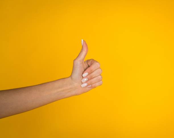 istock Woman hands over yellow background 1069310238
