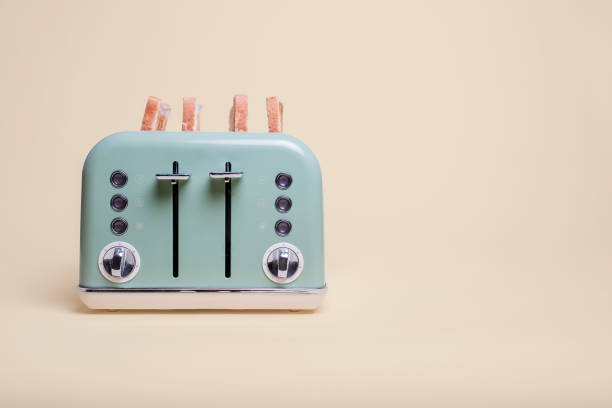 istock Retro green toaster with toast on yellow 1069312908
