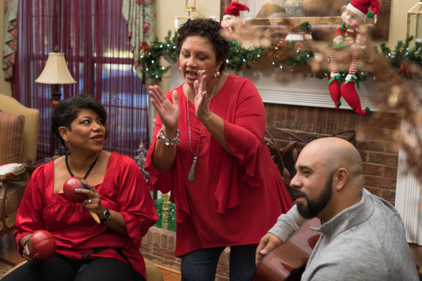 Family and friends dancing and playing musical instruments Multi-generation family and neighbors gather for a parranda. traditional song stock pictures, royalty-free photos & images