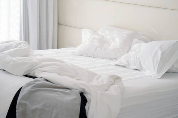 istock Dirty bed in the hotel. Dirty bed pillow blanket room. 1069315650