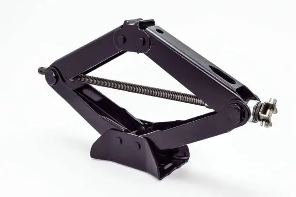 Photo of Manual scissor car jack, isolated on a white background with a clipping path.