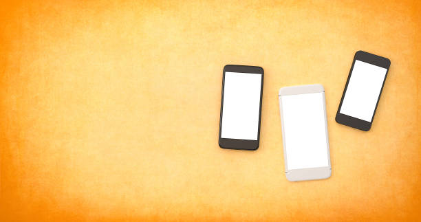 istock Mobile phones with white copy space on an orange background 1069326678