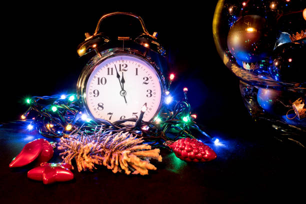 istock Silver Alarm Clock Showing Almost Twelve on Christmas Decorated Table 1069328768