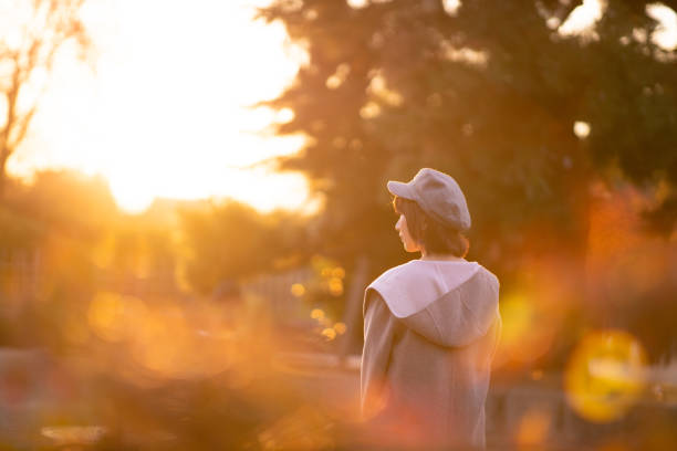 Young woman waiting for someone in public park at sunset time