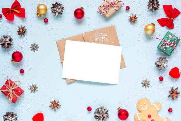 istock Christmas greeting card in frame made of christmas decorations, red berries, gift boxes and pine cones 1069342854