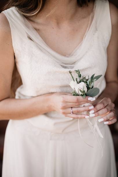 istock beautiful Bride in wedding dress with flowers 1069346660