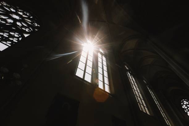 Beautiful view of sun shining through silhouette Church of the Sorrowful Mother of God against sky during sunrise
