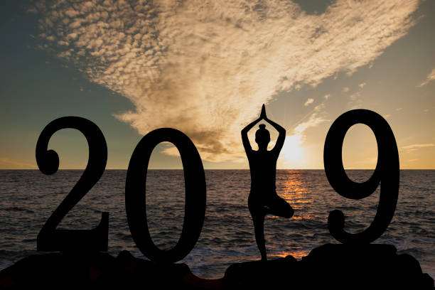 istock New year 2019 yoga concept woman pose 1069348314
