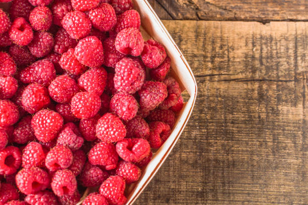 istock Eco berry. Healthy raspberry in basket on the wooden background. 1069358872