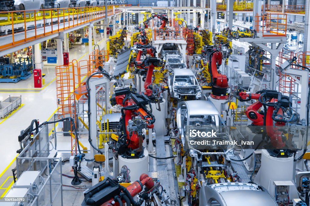 Automotive production line. Welding car body. Modern car Assembly plant Assembly line production of new car. Automated welding of car body on production line. robotic arm on car production line is working Manufacturing Stock Photo