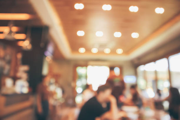 istock Restaurant cafe or coffee shop interior with customer blur abstract vintage style bokeh light for montage product display background 1069362062