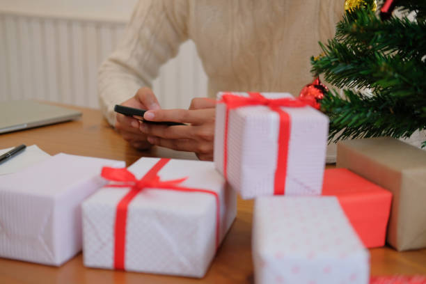 istock man using mobile smart phone with christmas decoration. xmas new year holiday celebration. 1069364774