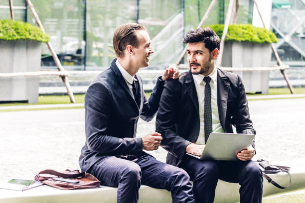 istock Image two business partners in black elegant suit talking and working together while discussing new strategy with laptop computer at city.Business and startup idea concept 1069368108