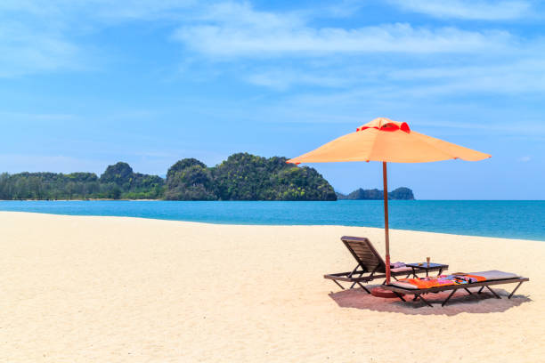 Sunloungers and a parasol on an empty Langkawi beach, Malaysia