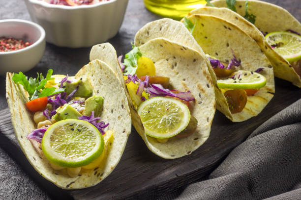 istock Healthy corn tortillas with chickpeas, tomatoes, avocado, fresh arugula, limes 1069373942