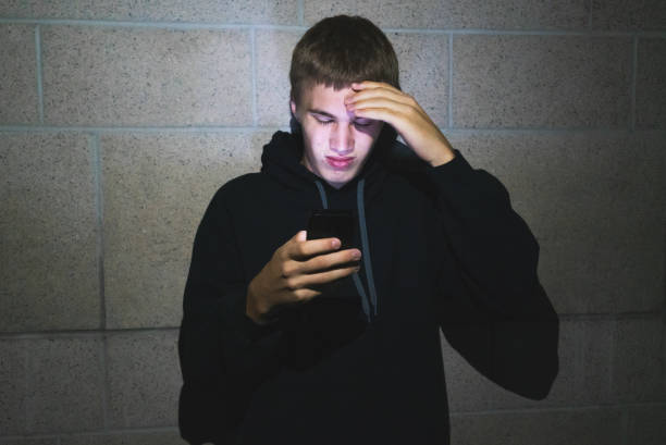 istock Teenager using mobile phone in the dark. 1069376440