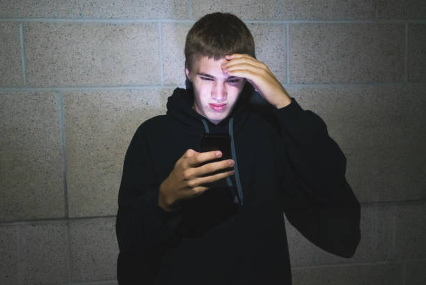 istock Teenager using mobile phone in the dark. 1069376488