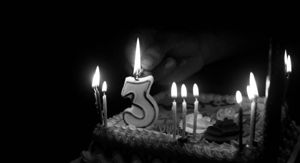istock Man lighting on a birthday candle unique photo 1069394958