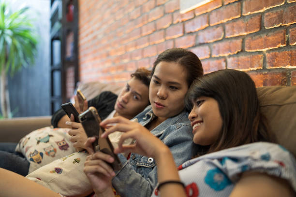istock young asian chilling indoor with smartphone 1069408232