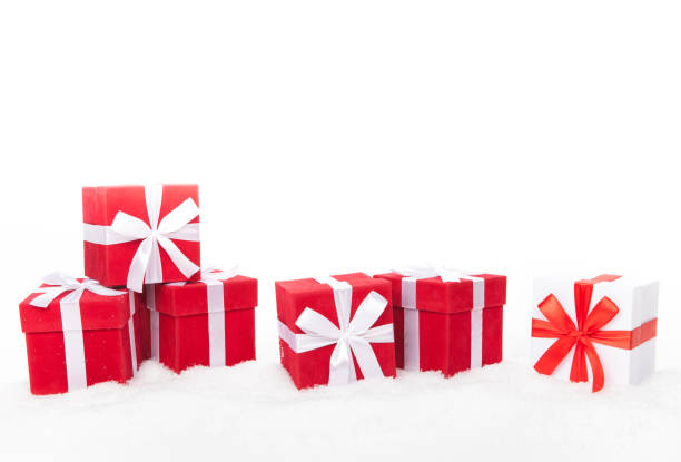 istock Christmas red and white gift boxes stay on a snow. Isolated on white 1069414596